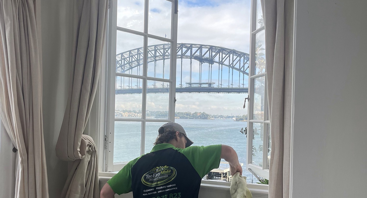 Too Easy Mate interior cleaning β washing windows with a harbour view